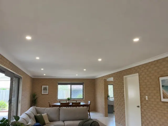 Living room with flush recessed downlights in a brick home interior in Pimpama